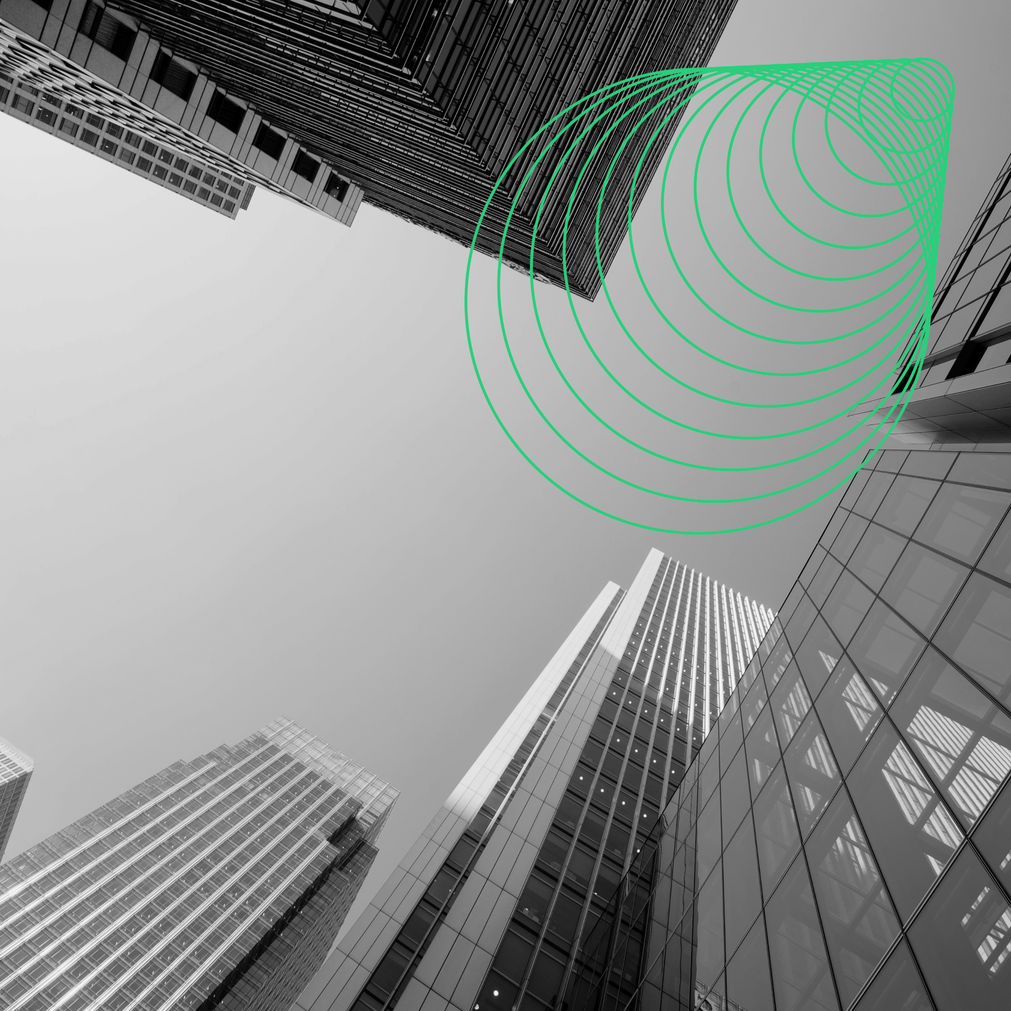 Looking up at glass office towers against a grey sky, with a green JOT circle graphic